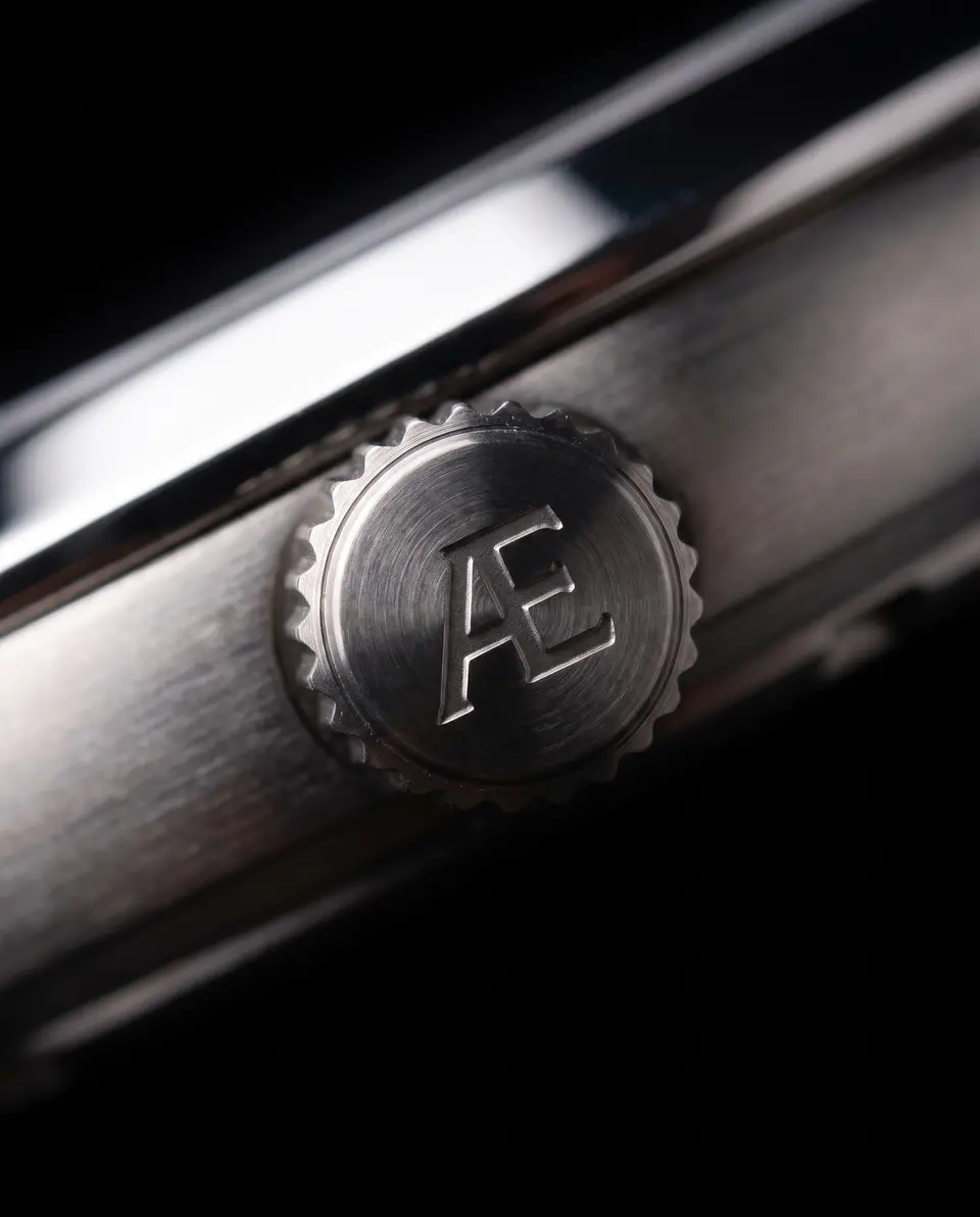 The fluted titanium crown, its end engraved with Æ.